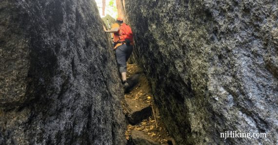 Hiker navigating the Lemon Squeezer on the Appalachian Trail.