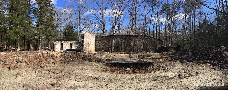 Stone wall ruins with multiple arches.