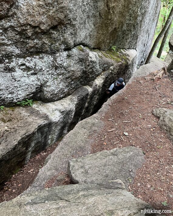 Hiker negotiating the lemon squeezer in Harriman.