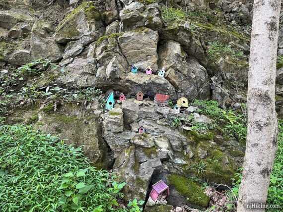 Little wooden houses nestled in a rock face.