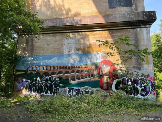 Mural of a Roman solider and bridge on the base of a viaduct.