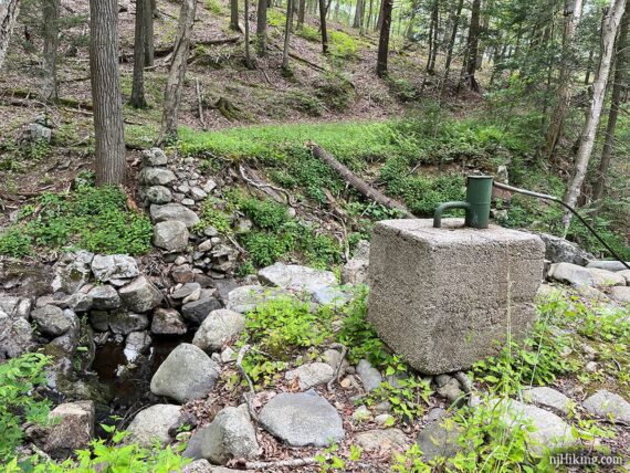 Stones and a square block from a ruined bridge.