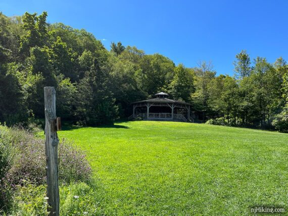 Gazebo pavilion across a grass field.