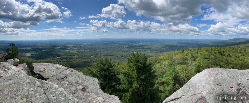 Gertrude's Nose viewpoint looking over forest and farms from a white cliff.