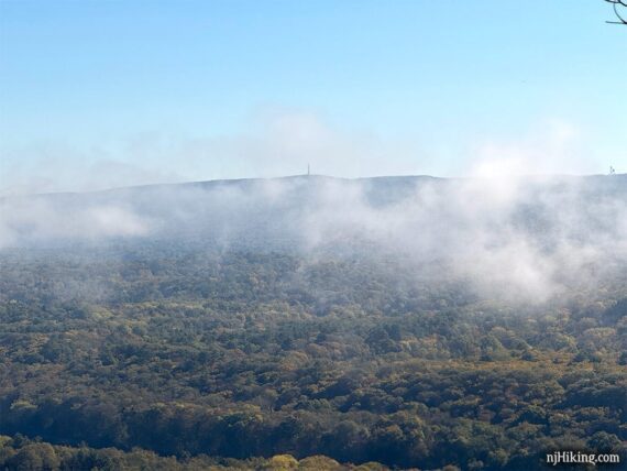 Zoom into High Point monument with clouds in front of it.