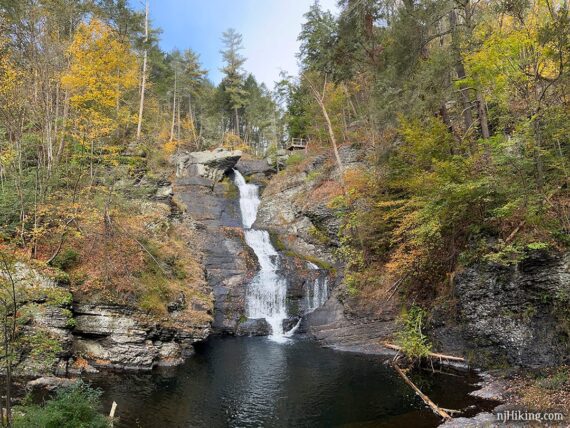 Raymondskill Falls surrounded by fall foliage.